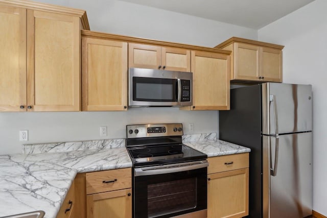 kitchen with stainless steel appliances, light stone countertops, and light brown cabinets