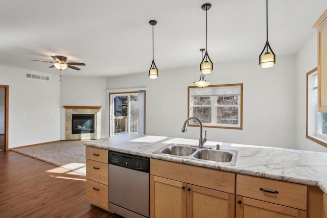 kitchen with plenty of natural light, dishwasher, sink, and hanging light fixtures