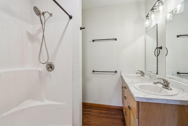 bathroom with vanity, hardwood / wood-style floors, and a shower