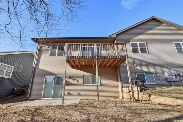 back of property with a yard and a patio