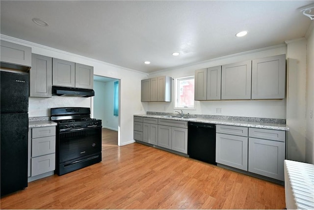 kitchen with sink, light hardwood / wood-style flooring, ornamental molding, gray cabinets, and black appliances