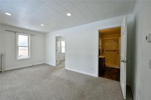 carpeted empty room with radiator