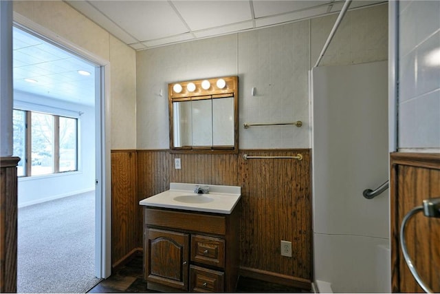 bathroom with vanity and wood walls