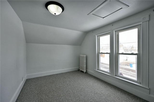 additional living space featuring lofted ceiling, radiator, and carpet