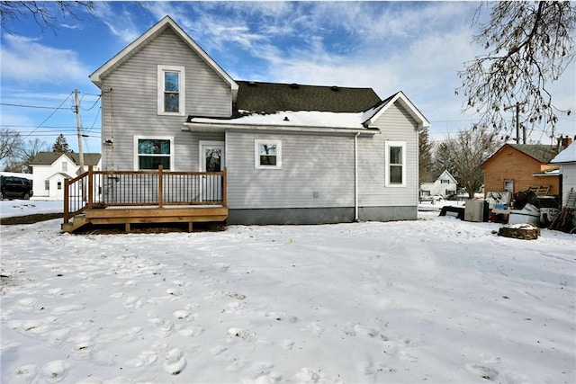 snow covered property featuring a deck