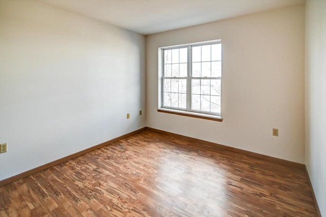 spare room featuring dark hardwood / wood-style flooring