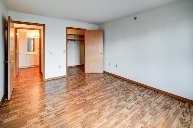 unfurnished bedroom featuring light hardwood / wood-style floors and a closet