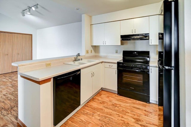 kitchen featuring sink, black appliances, kitchen peninsula, light hardwood / wood-style floors, and white cabinets