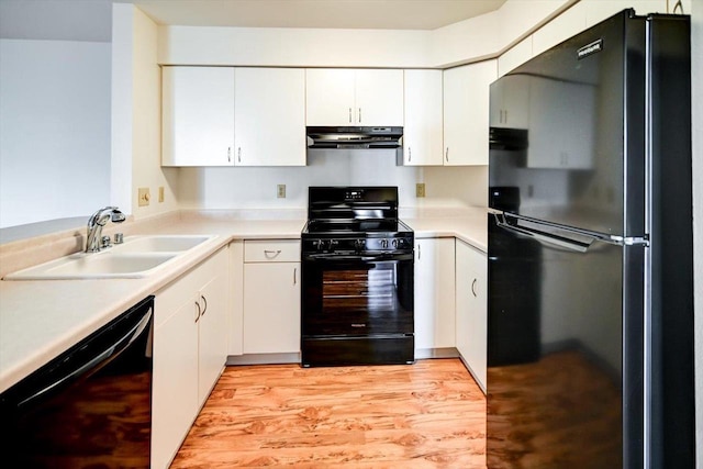 kitchen featuring white cabinets, sink, light hardwood / wood-style flooring, and black appliances