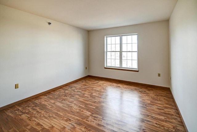 spare room featuring wood-type flooring