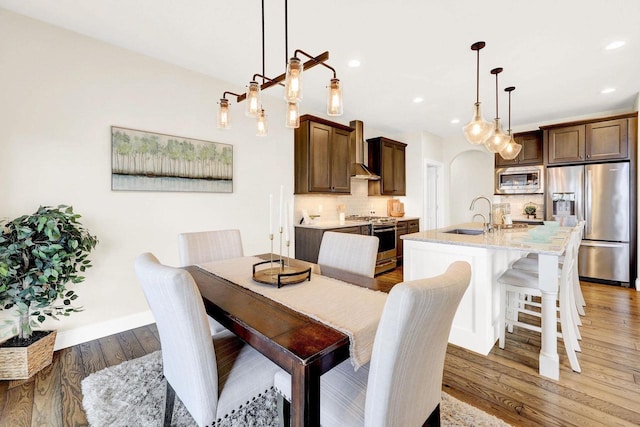 dining space featuring dark hardwood / wood-style flooring and sink