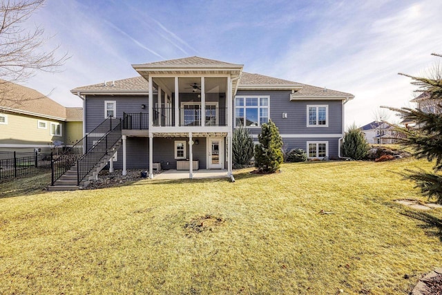 rear view of property featuring a patio, a yard, and ceiling fan