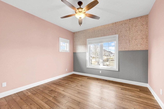 unfurnished room with ceiling fan and hardwood / wood-style floors