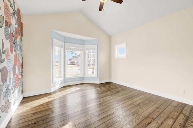 unfurnished room with wood-type flooring, lofted ceiling, and ceiling fan