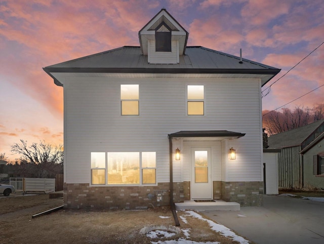 view of back house at dusk