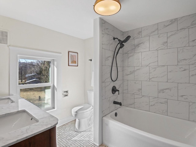 full bathroom with vanity, toilet, and tiled shower / bath combo