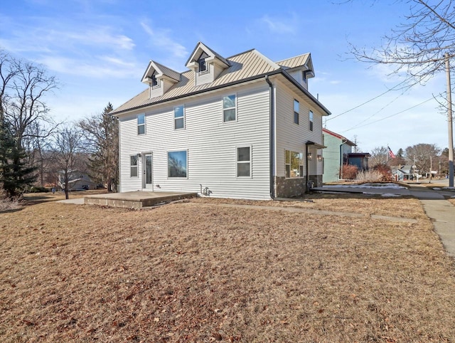 back of house featuring a patio and a lawn