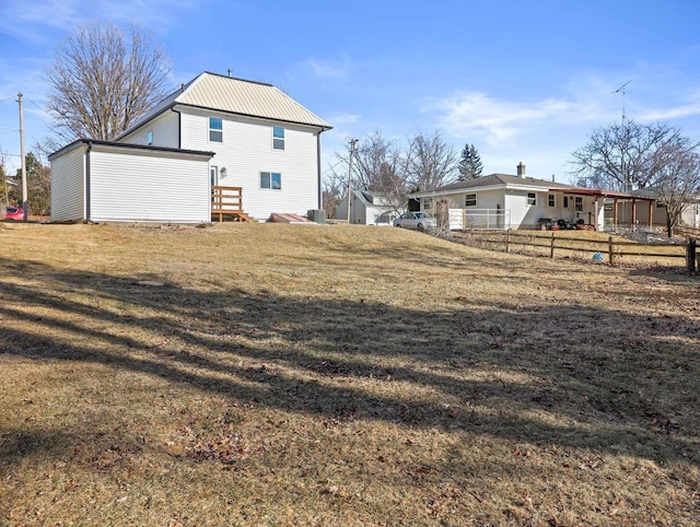 rear view of house with a yard