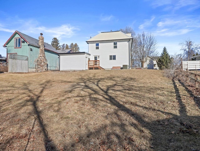 rear view of property with a lawn