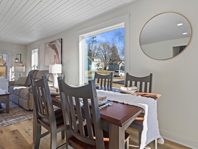 dining area featuring wood ceiling and light hardwood / wood-style flooring