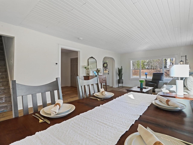 dining space with hardwood / wood-style flooring and wooden ceiling