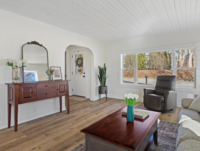 living room with wooden ceiling, wood-type flooring, and plenty of natural light