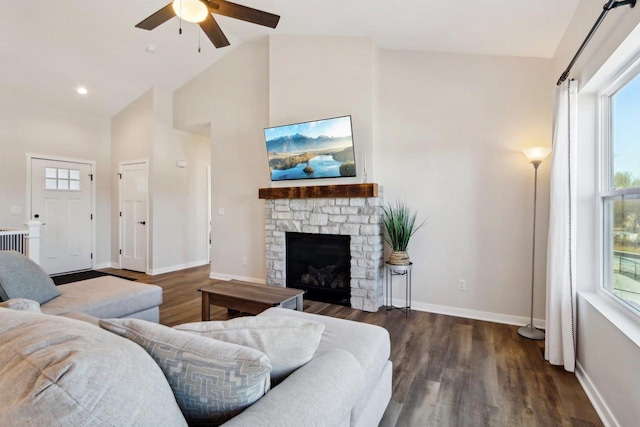 living room with a fireplace, dark wood-type flooring, high vaulted ceiling, and ceiling fan