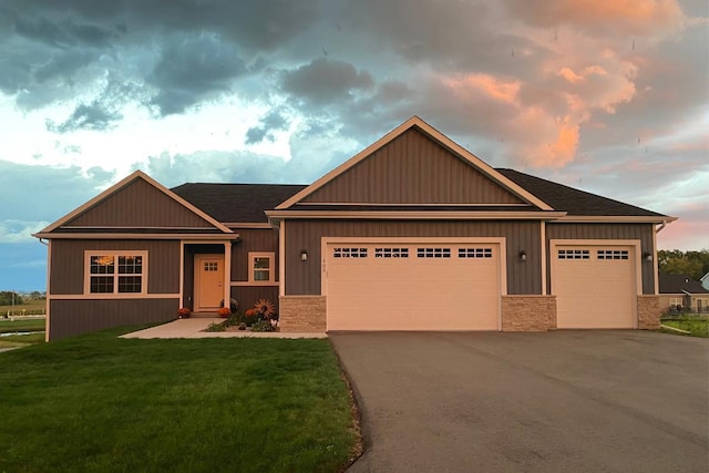 view of front of property with a garage and a yard