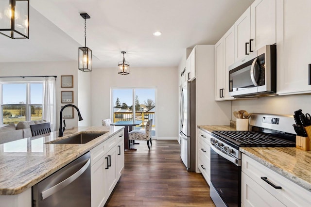 kitchen with stainless steel appliances, sink, and white cabinets