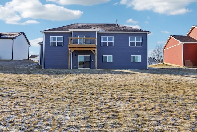 rear view of property featuring a lawn