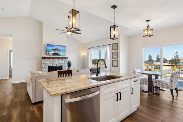 kitchen with sink, dishwasher, a kitchen island with sink, hanging light fixtures, and white cabinets