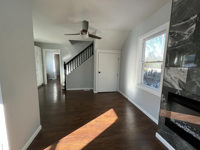 living room featuring dark hardwood / wood-style floors, ceiling fan, and a fireplace