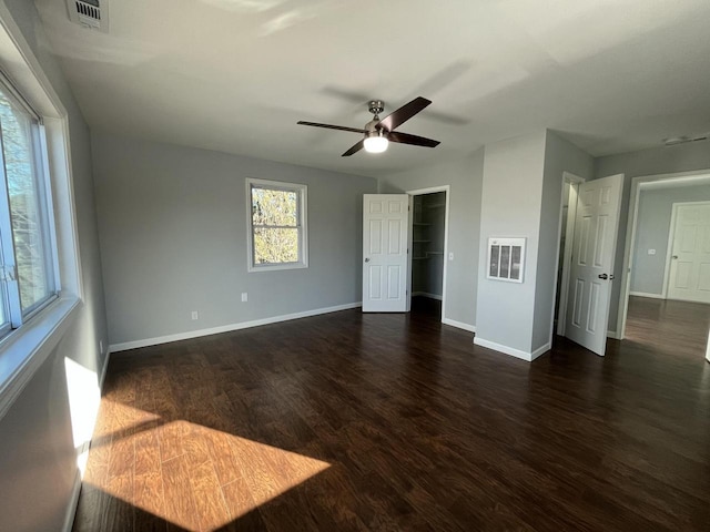 unfurnished bedroom with dark wood-type flooring and ceiling fan