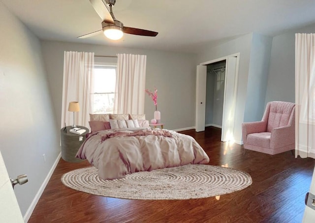 bedroom with a closet, dark hardwood / wood-style floors, and ceiling fan