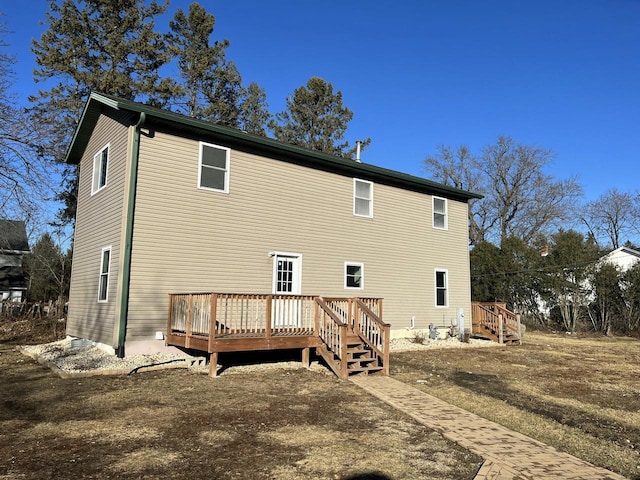 back of house featuring a wooden deck