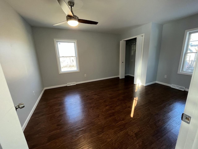 spare room with dark hardwood / wood-style floors and ceiling fan