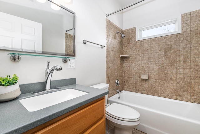 full bathroom with tiled shower / bath combo, vanity, and toilet