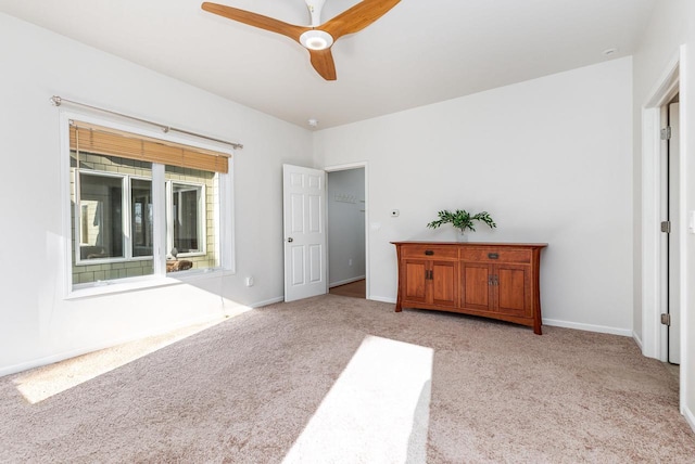 unfurnished bedroom featuring ceiling fan and light carpet