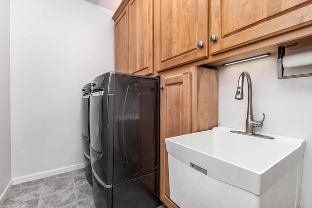 laundry area with separate washer and dryer, sink, light tile patterned floors, and cabinets