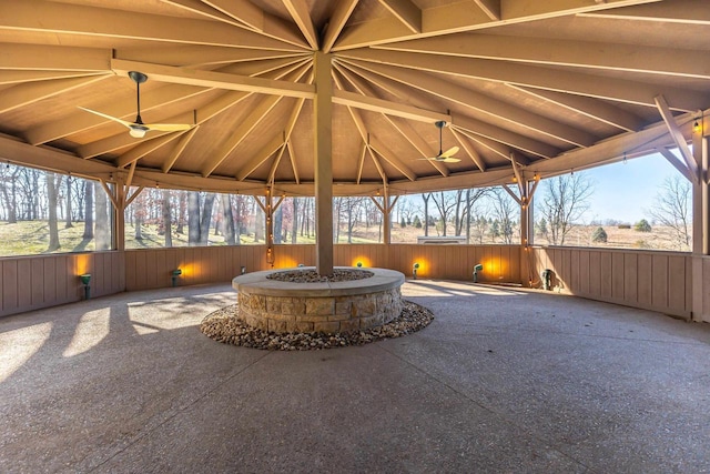 view of patio / terrace with a gazebo, ceiling fan, and a fire pit