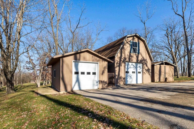 view of front of property with a garage and an outdoor structure