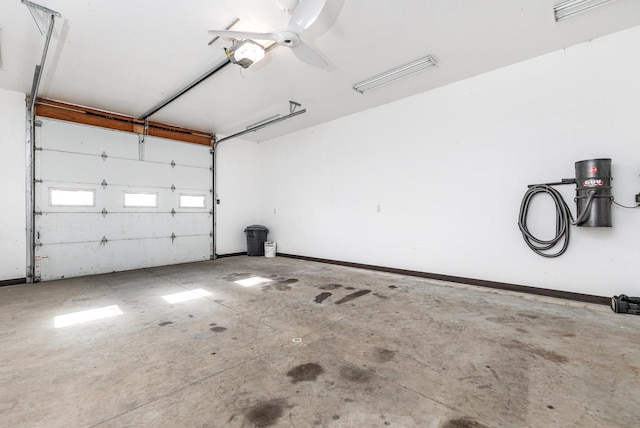 garage with ceiling fan and a garage door opener