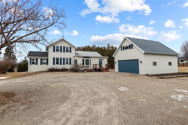 view of front of house featuring a garage and an outdoor structure