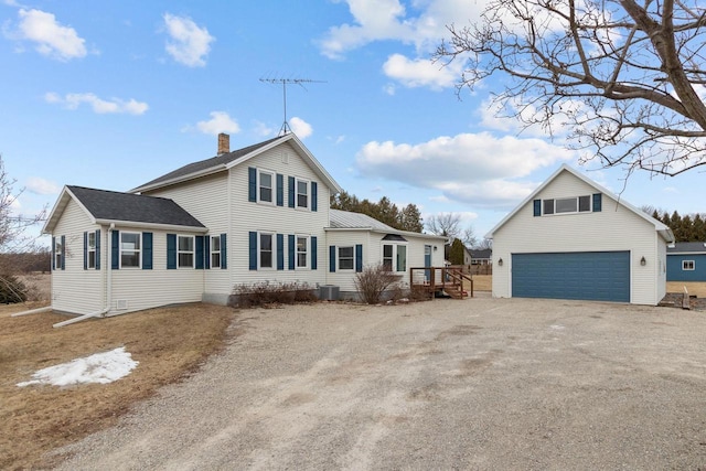 view of front of house featuring a garage and central AC