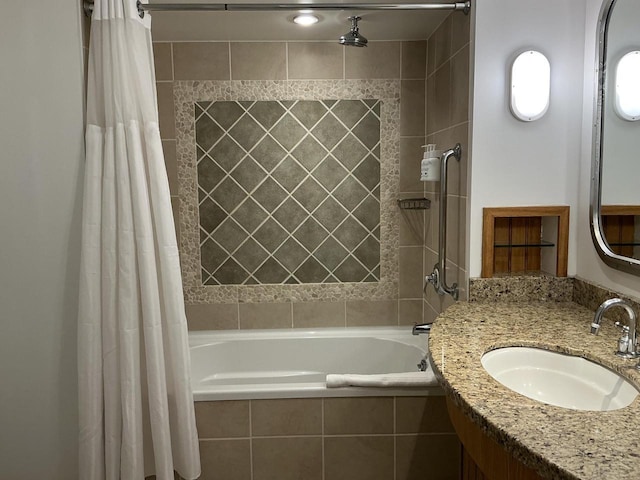 bathroom featuring shower / bath combo and vanity