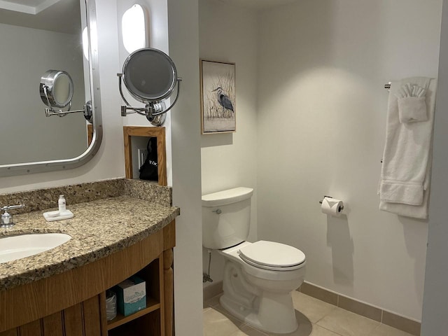 bathroom featuring vanity, tile patterned floors, and toilet