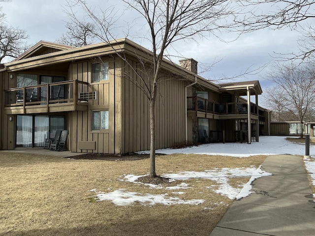 view of snow covered exterior featuring a balcony