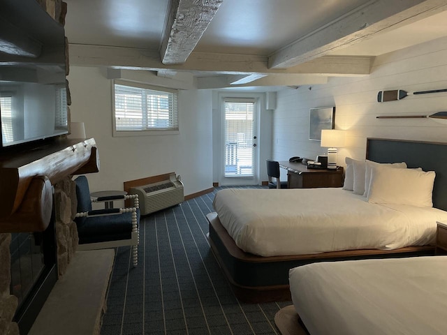 carpeted bedroom with beam ceiling