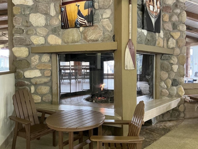 dining area featuring a stone fireplace