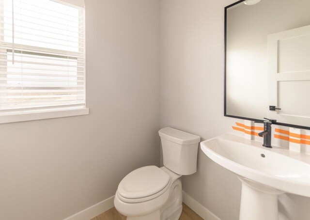 600 E Verleen Ave, Waunakee, WI 53597 - bathroom featuring toilet, a sink, and baseboards
